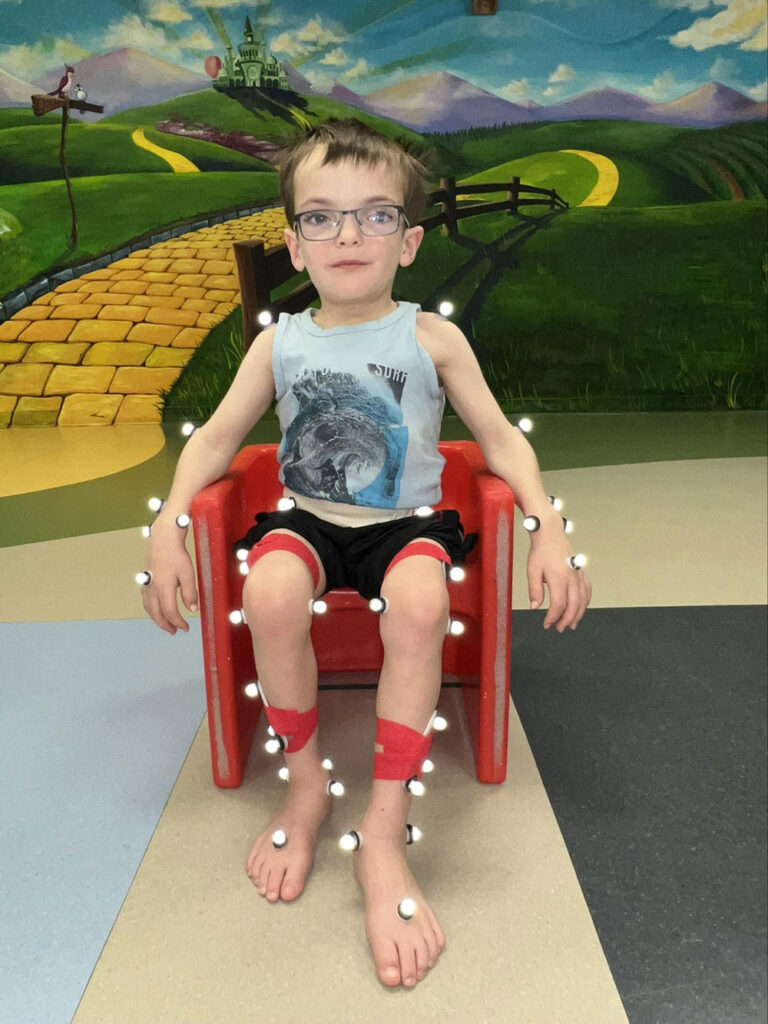 boy sitting in chair with motion tracking technology