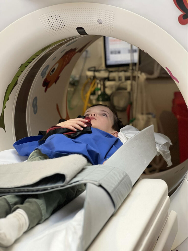 boy lying on high-tech scanner